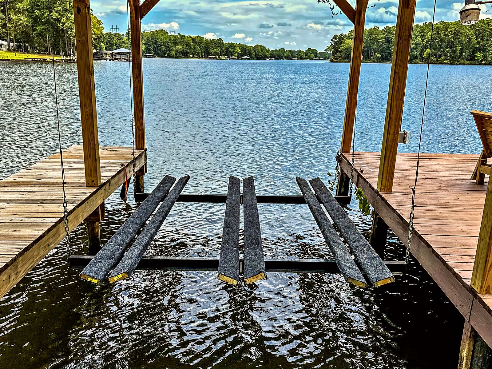 Boat lift bunks set over open water on Lake Sinclair under a clear sky