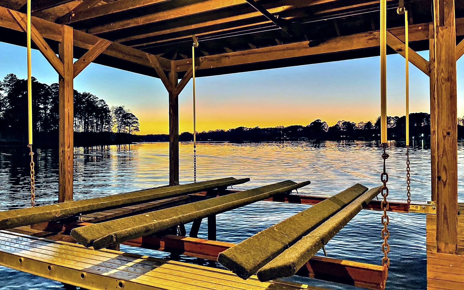 Boat lift and dock on Lake Sinclair at sunset