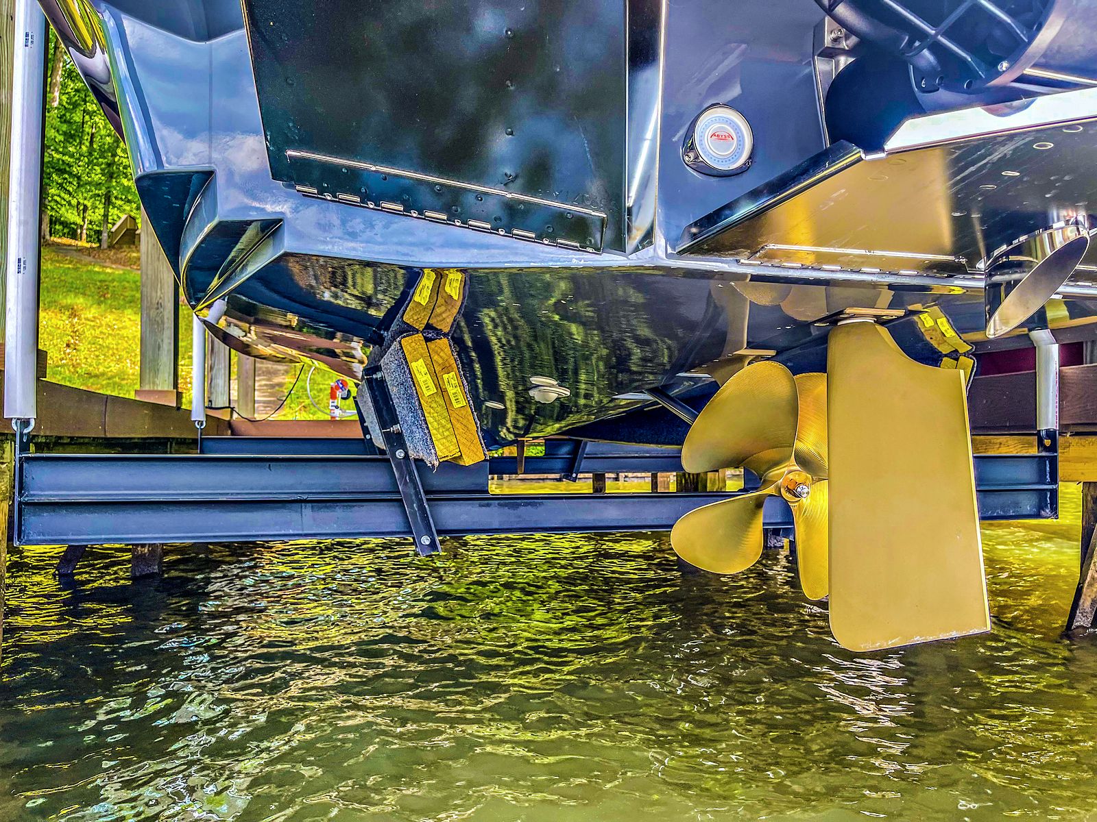 Inboard hull raised clear of the water, propeller and rudder above the surface